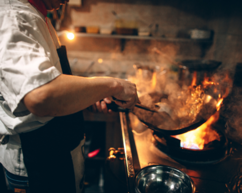 A chef cooking over an open flame